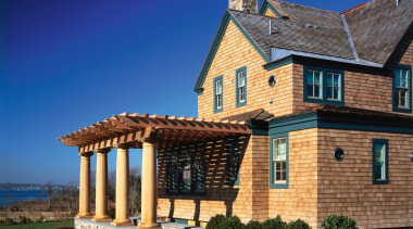 Exterior view of a wooden shingle house, green building, cottage, estate, facade, farmhouse, home, house, mansion, property, real estate, roof, sky, window, blue