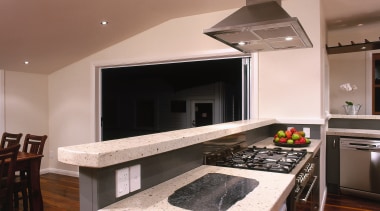 Kitchen with light coloured polished concrete benchtop and cabinetry, countertop, floor, flooring, hardwood, interior design, kitchen, room, wood flooring, brown, gray