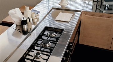 Closeup of kitchen benchtop with stainless steel top countertop, furniture, interior design, kitchen, product design, table, black, white