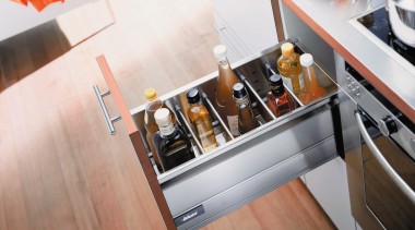 A view of a kitchen area, wooden flooring, countertop, floor, furniture, kitchen, product design, table, white