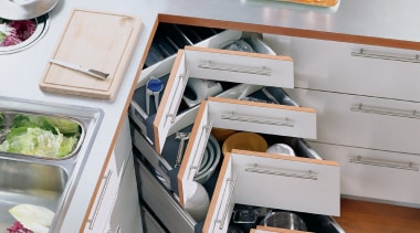 A view of a kitchen area, wooden flooring, drawer, furniture, kitchen, product design, shelf, shelving, table, gray