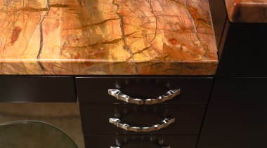 Closeup of bathroom vanity with gold coloured granite floor, flooring, furniture, hardwood, table, wall, wood stain, black