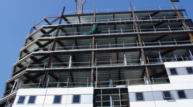 Exterior view of apartment building under construction. architecture, building, commercial building, condominium, construction, corporate headquarters, daytime, facade, headquarters, metropolis, metropolitan area, mixed use, residential area, scaffolding, sky, tower block, window, black, blue