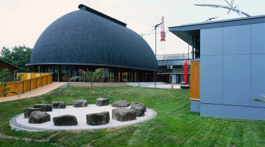 Exterior view of building with rounded roof, surrounding architecture, grass, house, real estate, roof, sky, white, green