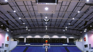 View of indoor basketball court with blue seating arena, auditorium, basketball court, ceiling, games, leisure centre, sport venue, sports, stadium, structure, gray