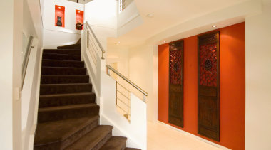 Stairwell with brown carpeted steps, cream walls and apartment, architecture, ceiling, daylighting, estate, floor, flooring, home, house, interior design, lobby, property, real estate, room, stairs, orange, brown