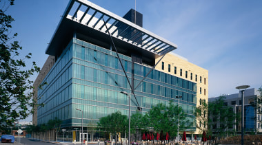 View of a large concrete, steel and glass architecture, building, city, commercial building, condominium, corporate headquarters, daytime, downtown, facade, headquarters, metropolis, metropolitan area, mixed use, real estate, residential area, sky, tower block, teal