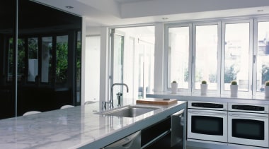 View of a kitchen, polished concrete flooring, marble cabinetry, countertop, cuisine classique, interior design, kitchen, real estate, window, gray, black