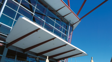 A view of the entrace to a large architecture, blue, building, daylighting, roof, sky, structure, water, blue