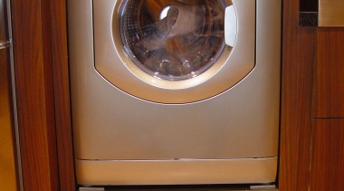 View of a silver clothes dryer in a clothes dryer, home appliance, laundry, major appliance, refrigerator, washing machine, brown