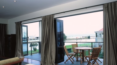 Hotel suite with powdercoated aluminium joinery, featuring bi-fold apartment, ceiling, condominium, interior design, property, real estate, room, suite, window, window treatment, gray, black