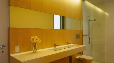 view of the beach house bathroom featuring white architecture, bathroom, ceiling, daylighting, floor, flooring, interior design, lighting, room, sink, wall, brown, orange