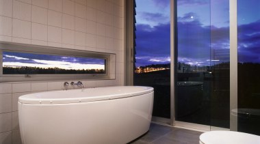 Bathroom with standalone white bath, tiled floor and architecture, bathroom, bathtub, floor, flooring, interior design, property, real estate, gray