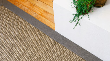 Closeup view of sisal rug on timber floor. floor, flooring, hardwood, tile, wood, wood stain, white, brown
