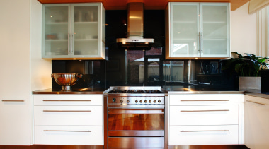 A view of a kitchen, wooden flooring, stainless cabinetry, countertop, cuisine classique, furniture, hardwood, home appliance, interior design, kitchen, kitchen stove, room, white