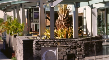 View of entranceway to Coro Hotel, featuring stone outdoor structure, black, gray