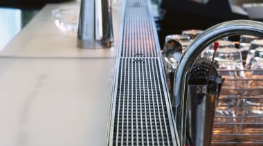 Stainless steel grating along length of bar in gray