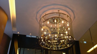 Custom made entrance light at the Hilton Sydney. architecture, ceiling, chandelier, light, light fixture, lighting, night, brown, gray