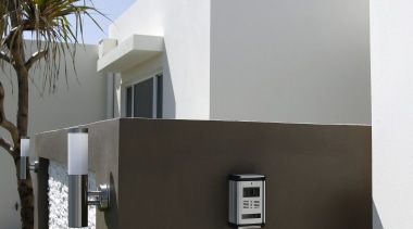 this unobtrusive camera, part of an infrared intercom architecture, building, facade, home, house, real estate, black, white