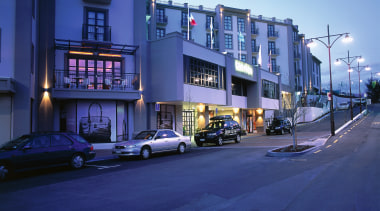 An exterior viewof the Soffitel hotel in Queenstown. architecture, building, car, city, downtown, evening, facade, family car, home, house, infrastructure, metropolitan area, mixed use, neighbourhood, night, real estate, residential area, road, sky, street, suburb, town, urban area, window, blue, teal