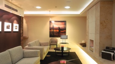 A view of the business lounge. - A ceiling, floor, interior design, lighting, living room, lobby, real estate, room, wall, brown, orange