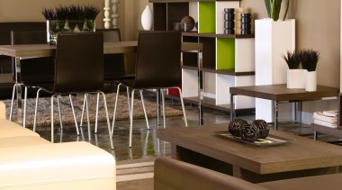 A view of a living area, polished concrete floor, flooring, furniture, interior design, living room, table, brown