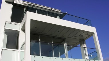 An exterior view of a modern apartment building. architecture, building, commercial building, facade, structure, blue, white, black