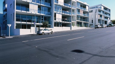 An exterior view of some apartments. - An apartment, architecture, building, commercial building, condominium, corporate headquarters, estate, facade, family car, home, house, metropolitan area, mixed use, neighbourhood, property, real estate, residential area, sky, suburb, window, black