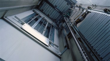 A view of the elevators within the complex. architecture, automotive exterior, building, daylighting, glass, line, roof, steel, gray, black