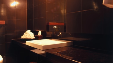 A view of the Kohler products used in bathroom, flooring, interior design, light, lighting, room, table, black