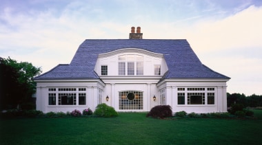 Exterior view of large home with white cladding, cottage, elevation, estate, facade, farmhouse, home, house, mansion, property, real estate, residential area, roof, shed, siding, sky, window, teal