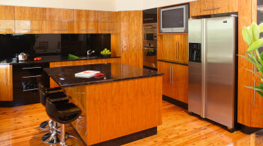 Kitchen with timber veneer, stainless steel appliances, black cabinetry, countertop, floor, flooring, hardwood, interior design, kitchen, laminate flooring, real estate, room, wood flooring, orange