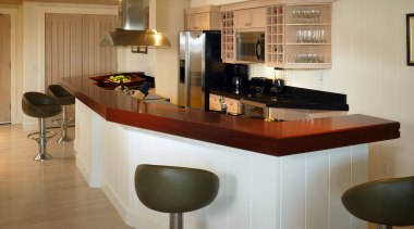 Kitchen with mahogony island countertop, black granite countertop, cabinetry, countertop, cuisine classique, floor, flooring, furniture, interior design, kitchen, room, brown, orange