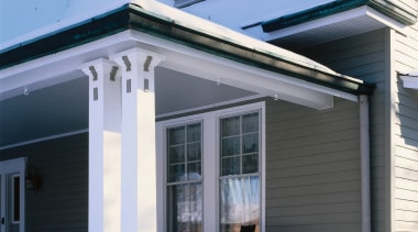 the witches hat dormar window  features a building, cottage, elevation, facade, home, house, porch, property, real estate, residential area, roof, siding, snow, window, winter, teal, black