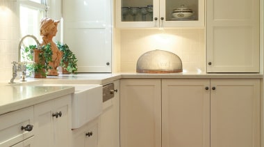 Kitchen with white cabinetry, metal handles, sunken sink, cabinetry, countertop, cuisine classique, floor, flooring, hardwood, home, home appliance, interior design, kitchen, laminate flooring, room, tile, wall, wood, wood flooring, wood stain, brown, orange