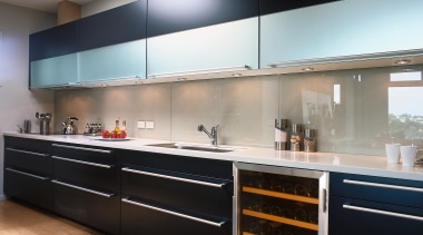 Kitchen with dark cabinetry, long chrome handles, and cabinetry, countertop, interior design, kitchen, black, gray