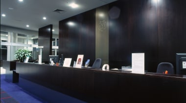 Counter area with timber counter and walll panelling. architecture, ceiling, interior design, lighting, lobby, black, gray