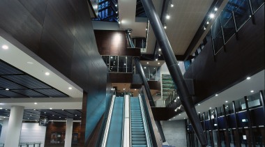 Interior of MCG entranceway showing large atrium, extensive airport terminal, architecture, building, daylighting, escalator, metropolitan area, structure, black, gray