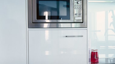 Kitchen with cream cabinetry and stainless steel microwave home appliance, kitchen, kitchen appliance, kitchen stove, major appliance, product, product design, refrigerator, gray