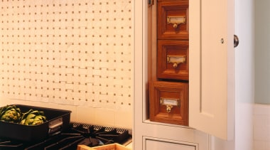 Kitchen with white traditional style cabinetry, spice drawers, cabinetry, countertop, furniture, home appliance, interior design, kitchen, major appliance, room, orange