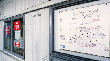 View of building's fire protection panels and schematic building, window, gray, white