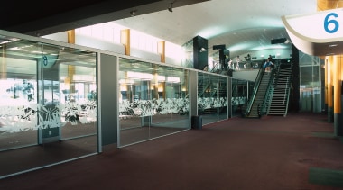 Fully glazed walkway next to stair and escalator. airport terminal, metropolitan area, black