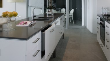 Kitchen with white cabinetry and black benchtop, and cabinetry, countertop, cuisine classique, floor, flooring, interior design, kitchen, room, tile, wood flooring, gray
