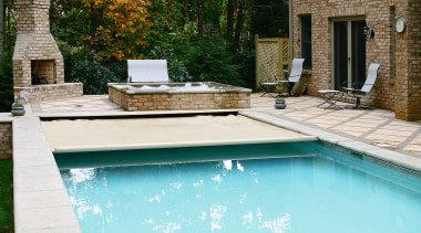 A view of a swimming pool. - A backyard, home, house, leisure, outdoor furniture, outdoor structure, real estate, reflection, residential area, swimming pool, water, water feature, wood, yard, teal, white