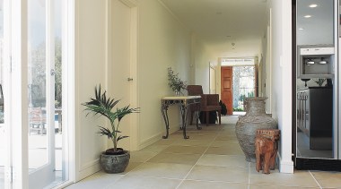Interior hallway with sandstone paver flooring. - Interior floor, flooring, home, interior design, laminate flooring, living room, property, real estate, room, tile, window, wood flooring, white