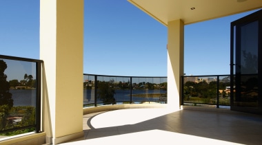 Large balcony with curved tinted glass balustrade. apartment, condominium, daylighting, door, estate, home, house, interior design, property, real estate, sky, window, teal