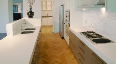 A view of a Far East Consortium apartment cabinetry, countertop, floor, flooring, hardwood, interior design, kitchen, laminate flooring, real estate, room, tile, wood flooring, gray, brown
