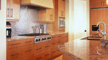 view of this kitchen featuring walnut coliseum Stone, cabinetry, ceiling, countertop, cuisine classique, floor, flooring, hardwood, home, interior design, kitchen, laminate flooring, room, tile, under cabinet lighting, wood flooring, orange, red