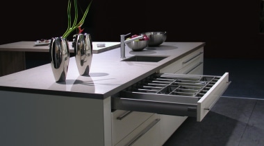 White and grey kitchen with large drawers and countertop, furniture, product design, table, black