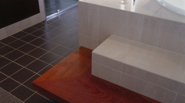 view of the tiled bath surround and timber bathroom, countertop, floor, flooring, hardwood, interior design, laminate flooring, sink, tile, wood, wood flooring, gray, red